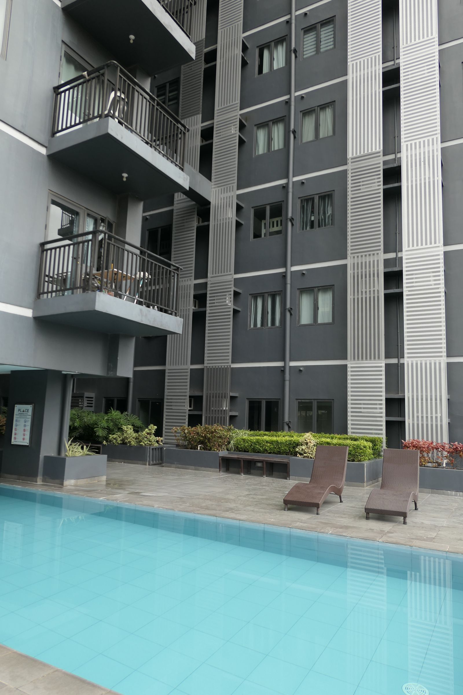 Modern multistory hotel exterior with balconies and guest areas